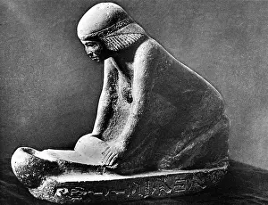 Grinding: Egyptian woman grinding corn using a saddle quern