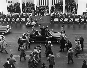 Inaugurations: Eisenhower waves from an open car in the inaugural