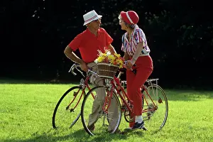 Retiree: Elderly couple with bicycles looking at one another