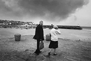 Gale: Elderly couple brave strong winds, West Pier, St Ives