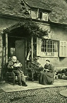 Comberton: Elderly couple outside cottage, Little Comberton, Worcs
