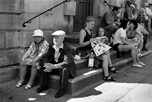 Philip Dunn: An elderly couple sitting on steps outside Bath Abbey