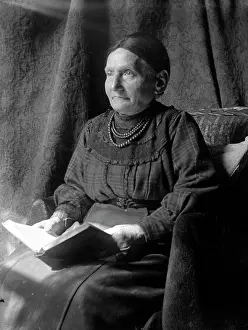 Venerable: Elderly lady sitting and reading a book