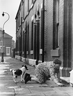 Elderly lady washing her step - Manchester 1968
