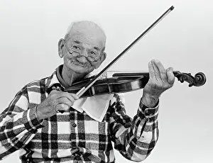 Toothless: Elderly man playing violin lookng at camera