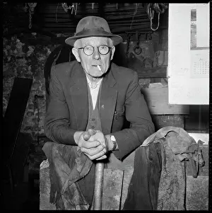 Tamar: An elderly man posed in a workshop, possibly a
