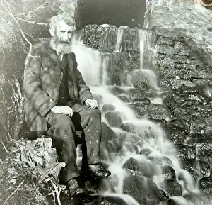 Outflow: Elderly man sitting by mill outflow