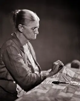 Quilting: Elderly Woman Sewing Working on a Patchwork Quilt