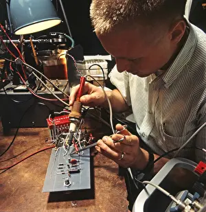 Soldering: An electrical engineer applies a soldering ?