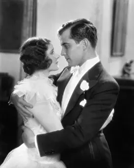 Coquettish: Elegant couple holding and looking at each other