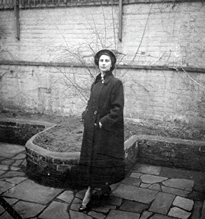 Paving: Elegant woman in overcoat and hat
