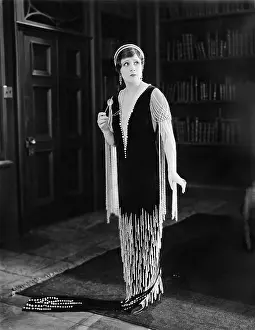 20 25: Elegant woman standing in a library