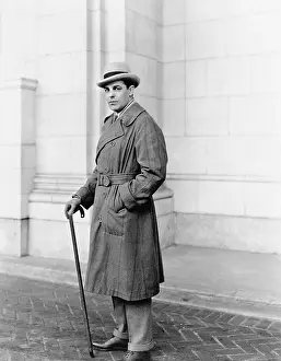 Mustaches: Elegantly dressed man standing in front of a building