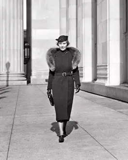 Classy: Elegantly Dressed Woman Walking along Sidewalk