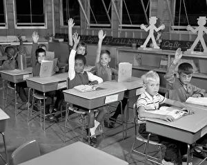 Hesitant: Elementary Classroom Students looking at Camera