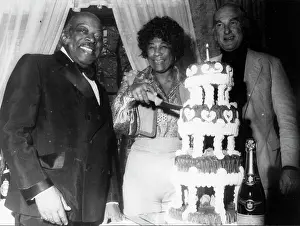 Tiers: Ella Fitzgerald and Count Basie with a large cake