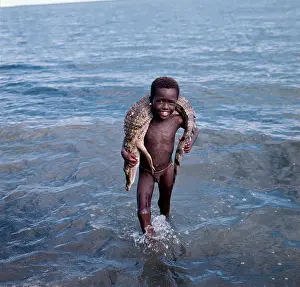 Turkana: Elmolo Boy with his catch, a crocodile on his