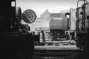 Barrow: Nine Elms Loco Yard with worker with barrow between locos