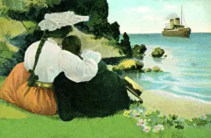 Embracing couple looking out to sea
