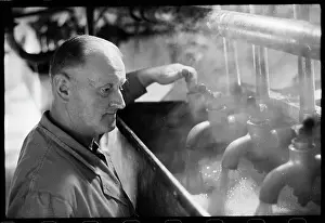 Mcmullens: An employee controlling hot wort flowing through