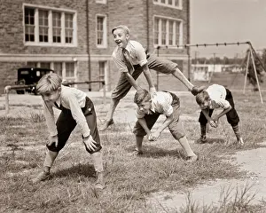 Stooped: Four Energetic Laughing Boys in Knickerbockers