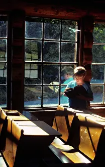 Schoolhouse: Engaged Curious Boy Reading Book While Visiting
