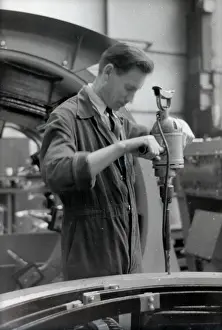Nigel Sorrell: An engineer in overalls working with a large hand drill