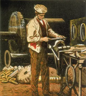 File: The Engineer using a file on an engine part held
