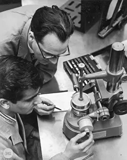 Measures: Two engineers using a measurement device