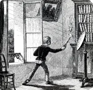 Focused: Engraving depicting a boy lighting paper using