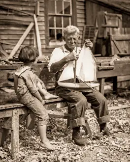 Barnegat: Engrossed Young Boy in Sailor Suit sitting with Elderly