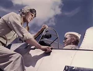 Cadet: Ensign and cadet talking by cockpit at Naval