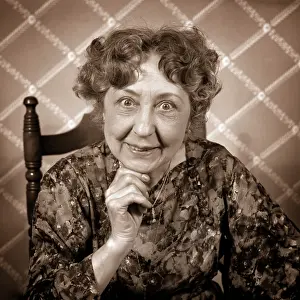 Idiosyncratic: Enthusiastic Elderly Woman Smiling Looking at