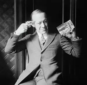 Forbidden: Ernie Hare holding an empty mug and a pistol