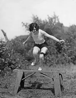Bizzare: Ethlyn Claire jumps over a dowel, 1927