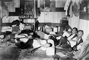 Addicts: Ethnic Chinese smoking in an opium den in ?