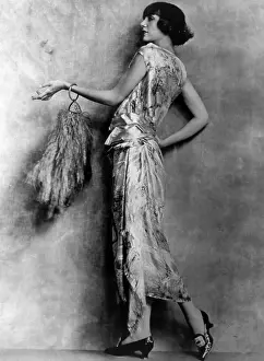 Brocaded: Evening gown of brocaded satin and feathered ?