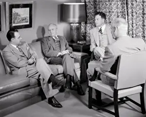 Brainstorming: Four Executive Men Having a Discussion Seated