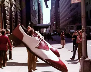 Moma: Exhibition image of men wearing large shoes