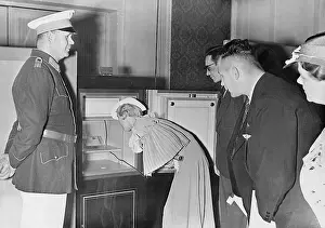 Stored: Exhibition visitor admires a stamp, 1937