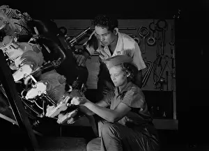 Supervisor: An expert mechanic shows a student the tricks