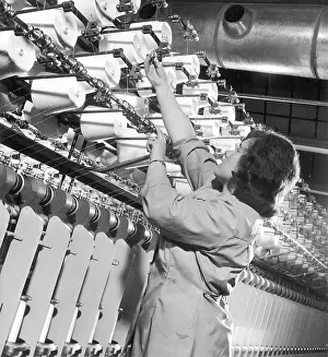 Complicated: Factory employee checks large Spinning Machine