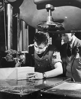 Apprentice: A factory worker cuts a block of wood