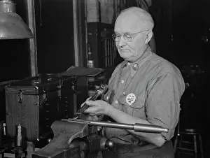 Clamp: Factory worker upsetting a reamer as part, 1943