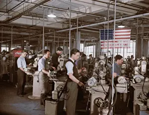 Grinding: Factory workers grinding small parts for machine