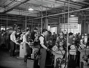 Grinding: Factory workers grinding small parts for machine