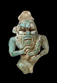 Amulets: Faience amulet of Bes nursing a Horus