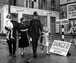 Defused: A family is escorted away from the site of an