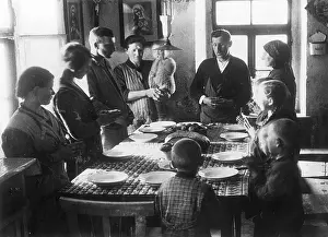 Gathers: Family gathers around a table and says grace
