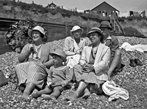 Pebbly: Family group on a pebbly beach at the seaside